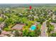 Aerial view of a residential community featuring well-maintained homes, a pool, and tennis courts, promoting an active lifestyle at 2252 S Queen St, Lakewood, CO 80227