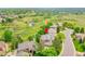 Aerial view of a home nestled among lush greenery and a serene pond, showcasing its peaceful and private location at 2252 S Queen St, Lakewood, CO 80227