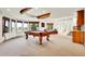 Finished basement featuring a pool table, bar and dining area, and large windows at 2252 S Queen St, Lakewood, CO 80227