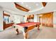 Finished basement features a pool table, a dry bar with wine storage, and barn door at 2252 S Queen St, Lakewood, CO 80227