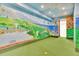 Basement offers recreation with a mini golf course and tropical-themed murals at 2252 S Queen St, Lakewood, CO 80227