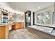 Bright bathroom features a soaking tub, a glass enclosed shower and light oak cabinetry at 2252 S Queen St, Lakewood, CO 80227