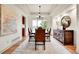 Bright dining room with large windows, hardwood floors and stylish chandelier creates an inviting atmosphere at 2252 S Queen St, Lakewood, CO 80227