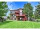 Spacious home with a large backyard, multi-level decks, and mature trees, perfect for outdoor living and entertaining at 2252 S Queen St, Lakewood, CO 80227