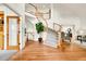 Grand foyer with curved staircase, hardwood floors, and elegant architectural details at 2252 S Queen St, Lakewood, CO 80227
