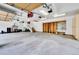Spacious garage with storage shelves, overhead lighting, and stairs to the main house at 2252 S Queen St, Lakewood, CO 80227