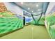 Fun golf room with green carpet, a net, and picturesque ocean view wall decor at 2252 S Queen St, Lakewood, CO 80227