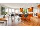 Open kitchen and breakfast nook featuring wood floors, granite counters, and stainless steel appliances at 2252 S Queen St, Lakewood, CO 80227