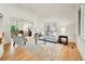 Bright living room with hardwood floors, large windows, and stylish furniture at 2252 S Queen St, Lakewood, CO 80227