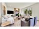 Comfortable living room features a brick fireplace, large window and plush seating at 2252 S Queen St, Lakewood, CO 80227