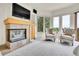 Cozy living room boasts fireplace, flat screen television, and oversized windows allowing abundant natural light at 2252 S Queen St, Lakewood, CO 80227