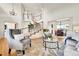 Elegant living space with curved staircase, hardwood floors, and comfortable seating at 2252 S Queen St, Lakewood, CO 80227