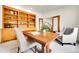 Cozy office space with built-in bookshelves, a wooden table and comfortable seating at 2252 S Queen St, Lakewood, CO 80227