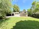 Backyard view showcases the house and yard with lush greenery, perfect for relaxation at 8426 W Woodard Dr, Lakewood, CO 80227