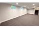 Finished basement with new carpet, and natural light from the two small windows at 8426 W Woodard Dr, Lakewood, CO 80227