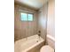 Updated bathroom featuring tiled shower, tub and neutral color scheme at 8426 W Woodard Dr, Lakewood, CO 80227