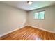 Bright bedroom featuring hardwood floors and a bright, leafy window at 8426 W Woodard Dr, Lakewood, CO 80227