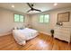 Light-filled bedroom with hardwood floors and two bright, leafy windows at 8426 W Woodard Dr, Lakewood, CO 80227