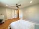 Comfortable bedroom featuring hardwood floors and a neutral color scheme at 8426 W Woodard Dr, Lakewood, CO 80227