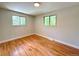 Bright bedroom featuring hardwood floors and two bright, leafy windows at 8426 W Woodard Dr, Lakewood, CO 80227