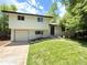 Charming two-story home featuring a well-manicured lawn and attached garage at 8426 W Woodard Dr, Lakewood, CO 80227
