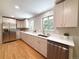Modern kitchen with stainless steel appliances, sleek countertops, and ample storage at 8426 W Woodard Dr, Lakewood, CO 80227