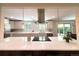 Bright, updated kitchen featuring a large island and stainless steel appliances at 8426 W Woodard Dr, Lakewood, CO 80227