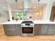 Stylish eat-in kitchen with stainless oven, quartz countertops, and modern finishes at 8426 W Woodard Dr, Lakewood, CO 80227