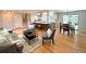 Bright and airy living room featuring hardwood floors and access to the dining area at 8426 W Woodard Dr, Lakewood, CO 80227