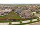 An aerial perspective highlighting the property's backyard, patio, and the surrounding homes within a developed neighborhood at 13205 E 109Th Ave, Commerce City, CO 80022