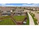 Aerial view of a home showcasing a well-kept lawn, patio, and privacy fence, surrounded by neighborhood streets at 13205 E 109Th Ave, Commerce City, CO 80022