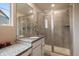 Bathroom featuring vanity, granite countertops, and tiled shower with a glass door at 13205 E 109Th Ave, Commerce City, CO 80022
