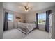 Cozy bedroom with a ceiling fan, two windows, and hardwood floors at 13205 E 109Th Ave, Commerce City, CO 80022