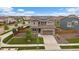 Beautiful two-story home featuring solar panels, a manicured lawn, and a two-car garage at 13205 E 109Th Ave, Commerce City, CO 80022