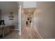 Long hallway with wood floors, neutral walls, and views into other rooms at 13205 E 109Th Ave, Commerce City, CO 80022