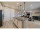 Kitchen island featuring pendant lighting and granite countertops that leads into the living room and dining area at 13205 E 109Th Ave, Commerce City, CO 80022