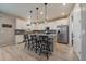 Modern kitchen with granite countertops, island with bar seating, stainless steel appliances, and wood-look flooring at 13205 E 109Th Ave, Commerce City, CO 80022