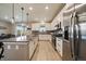 Bright kitchen with stainless steel appliances, granite countertops, gray backsplash, and center island with bar stool seating at 13205 E 109Th Ave, Commerce City, CO 80022