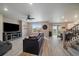 Open living room with wood-like floors, a fireplace, and a comfortable sectional sofa at 13205 E 109Th Ave, Commerce City, CO 80022