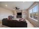 Comfortable living room with wood-like floors, a fireplace, and ample natural light at 13205 E 109Th Ave, Commerce City, CO 80022