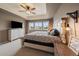 Main bedroom suite featuring tray ceiling, carpet, large windows, and light fixtures at 13205 E 109Th Ave, Commerce City, CO 80022