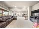 Large finished basement featuring a media area with plush sofa and a sliding glass door at 756 Ranchhand Dr, Berthoud, CO 80513