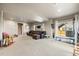 Spacious finished basement with plush carpeting and a comfortable leather sectional at 756 Ranchhand Dr, Berthoud, CO 80513