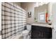 Cozy bathroom featuring a combination tub and shower with modern fixtures and vanity at 756 Ranchhand Dr, Berthoud, CO 80513