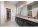 Bathroom with double vanity sinks, granite countertops, and a walk-in closet at 756 Ranchhand Dr, Berthoud, CO 80513