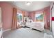 Pink bedroom offers two windows allowing natural light and providing outdoor view at 756 Ranchhand Dr, Berthoud, CO 80513