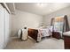 Cozy bedroom with a classic bed frame, neutral carpet, and natural light from the window at 756 Ranchhand Dr, Berthoud, CO 80513