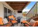 Covered patio with an outdoor lounge area, comfortable seating, a TV, and string lights at 756 Ranchhand Dr, Berthoud, CO 80513