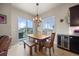 Dining area with a rustic table and chairs, sliding glass doors to the backyard at 756 Ranchhand Dr, Berthoud, CO 80513