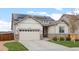 Charming home with a stone and siding exterior, solar panels, an attached garage, and a well-manicured lawn at 756 Ranchhand Dr, Berthoud, CO 80513